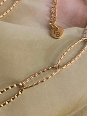 Schakelarmband twisted goud - LEEF mode en accessoires