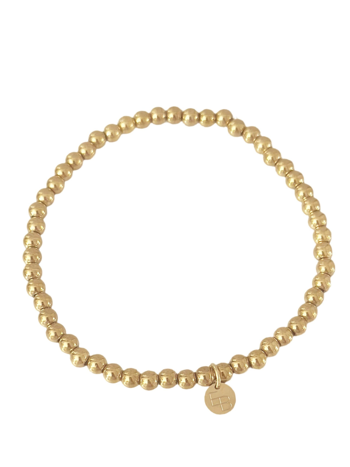 Goudkleurig balletjes armbandje van 3mm van Ellen Beekmans, close-up van de glanzende, sierlijke armband op een witte achtergrond.