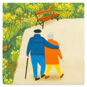 Twee geliefden die hand in hand staan, afgebeeld op een muurkunstwerk van het merk StoryTiles met de tekst 'Couple Goals 10x10'.